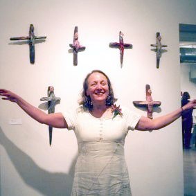 Photograph of Alice Sharie-Revelski in front of her "herb angels"