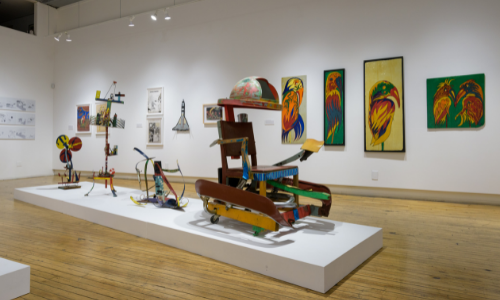 Photograph of works of art, including sculptures and paintings, by Charles Williams on exhibition in the front gallery of Intuit