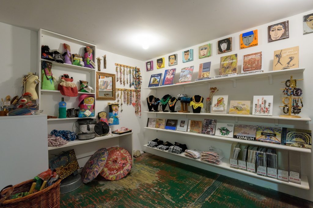 Photograph of the Intuit Store, featuring art objects, clothing items and publications on shelves